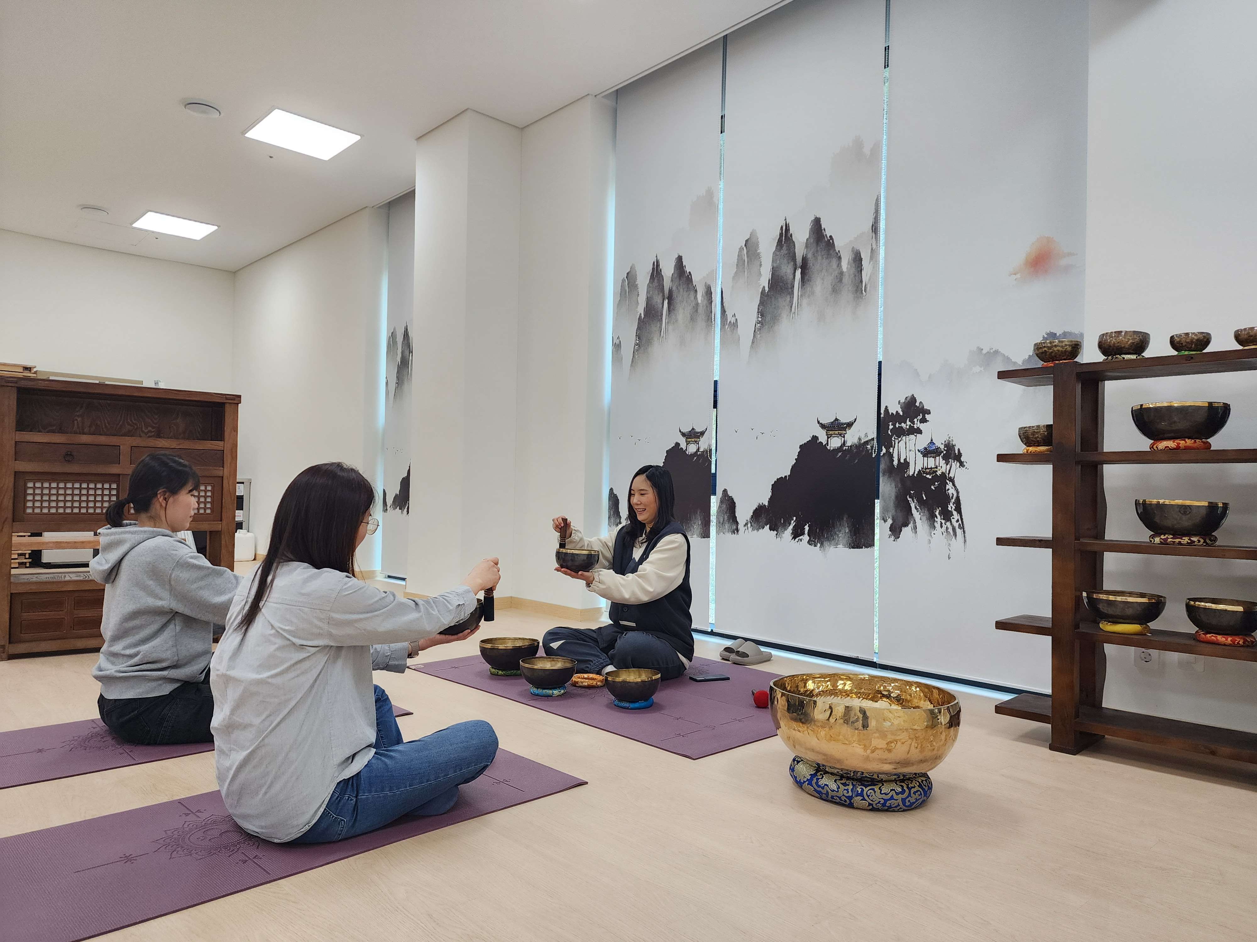 다음은 싱잉볼 명상 체험이에요.싱잉볼이란 노래하는 그릇'이라는 뜻을 가진 명상 도구입니다. 주로 히말라야 지역(티베트, 네팔 등)에서 유래했으며, 스틱이나 해머로 가장자리를 문지르거나 두드렸을 때 발생하는 풍부한 소리와 진동이 특징입니다.싱잉볼의 울림을 통해 몸속 긴장을 풀고 깊은 이완 상태로 유도하는 명상 프로그램입니다.소리와 진동을 통해 감정 안정과 스트레스 완화 효과를 느낄 수 있습니다.